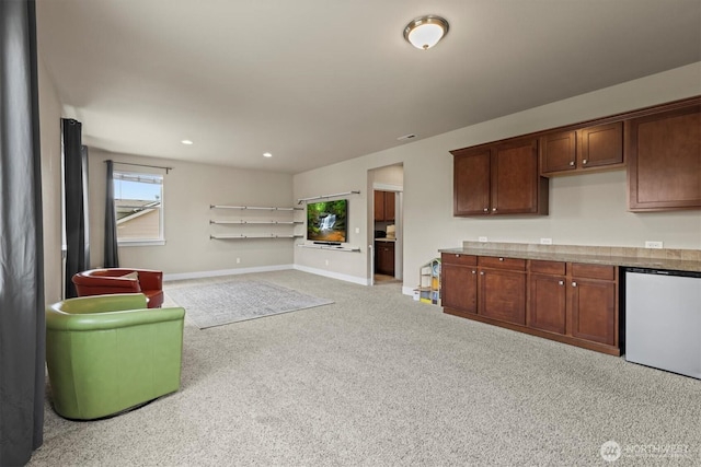 8910 Buttercup St SE, Tumwater, WA 98501 - kitchen with refrigerator, carpet floors, open floor plan, recessed lighting, and light countertops