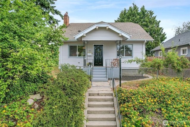 1211 S 41st St, Tacoma, WA 98418 - bungalow-style house featuring a porch, a chimney, roof with shingles, and a gate