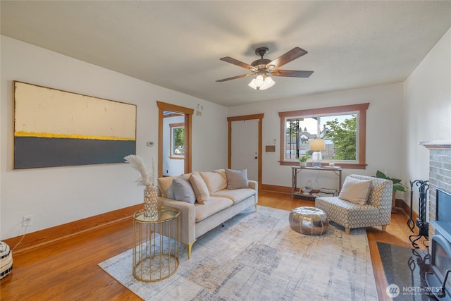 1211 S 41st St, Tacoma, WA 98418 - living room with wood finished floors, a brick fireplace, and ceiling fan