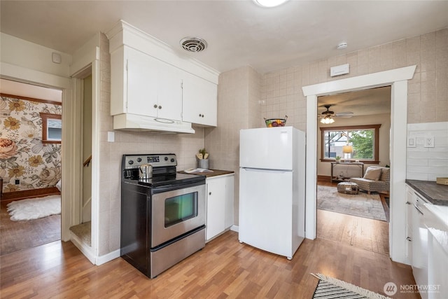 1211 S 41st St, Tacoma, WA 98418 - kitchen with freestanding refrigerator, electric range, under cabinet range hood, and light wood finished floors