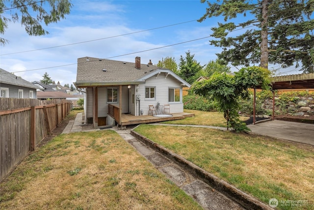 1211 S 41st St, Tacoma, WA 98418 - rear view of property featuring a deck, a fenced backyard, a patio, a chimney, and a shingled roof