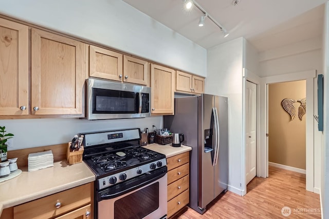 23120 SE Black Nugget Rd Unit D1, Issaquah, WA 98029 - kitchen featuring stainless steel appliances, light brown cabinets, track lighting, light wood-type flooring, and light countertops
