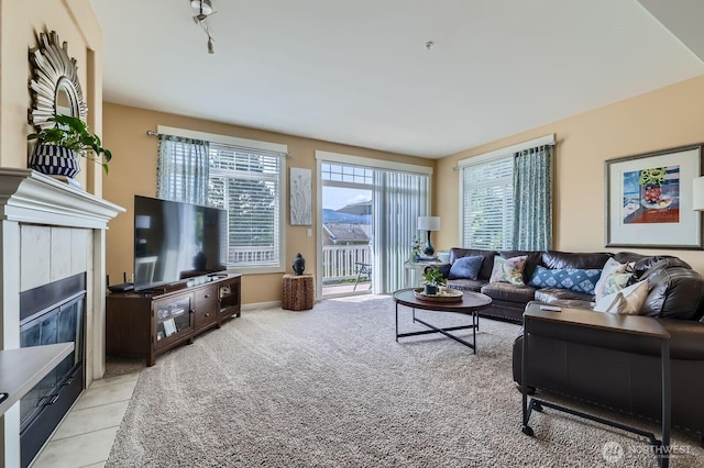 23120 SE Black Nugget Rd Unit D1, Issaquah, WA 98029 - living room featuring a tiled fireplace and light carpet