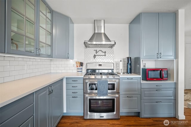 6084 Summit View Pl, Ferndale, WA 98248 - kitchen featuring double oven range, wall chimney range hood, backsplash, and light countertops