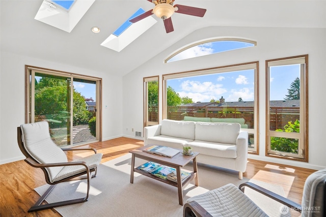 6084 Summit View Pl, Ferndale, WA 98248 - living room with vaulted ceiling, a skylight, healthy amount of natural light, wood finished floors, and a ceiling fan