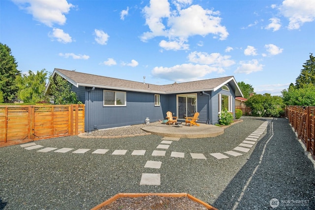 6084 Summit View Pl, Ferndale, WA 98248 - back of property featuring a patio area, a fenced backyard, and an outdoor fire pit