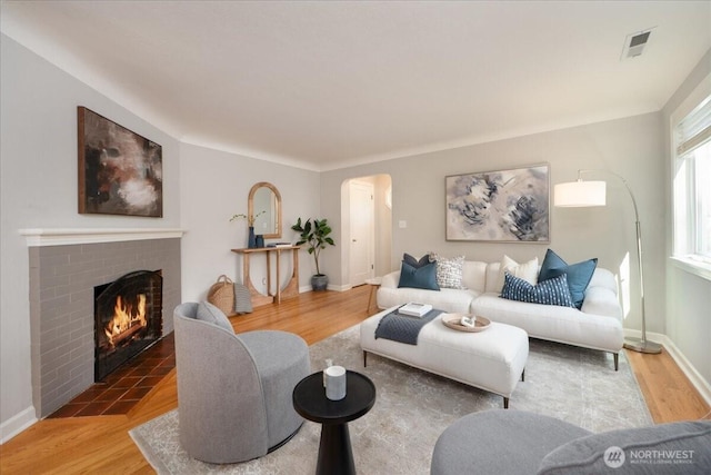 2321 NE 127th St, Seattle, WA 98125 - living area featuring arched walkways, wood finished floors, and a fireplace