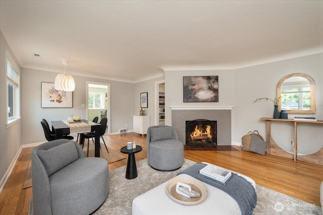 2321 NE 127th St, Seattle, WA 98125 - living area featuring wood finished floors, plenty of natural light, and a brick fireplace