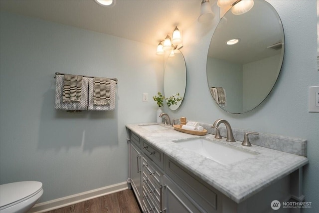 2321 NE 127th St, Seattle, WA 98125 - bathroom featuring wood finished floors and double vanity