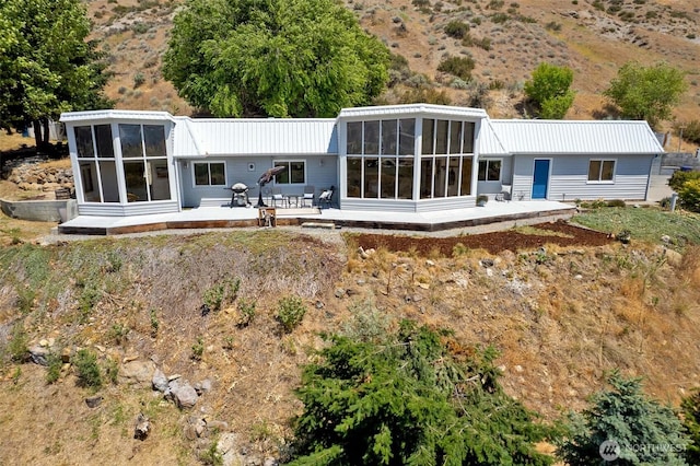 71 Blue Grade Rd, East Wenatchee, WA 98802 - rear view of property with a sunroom, a metal roof, and a wooden deck