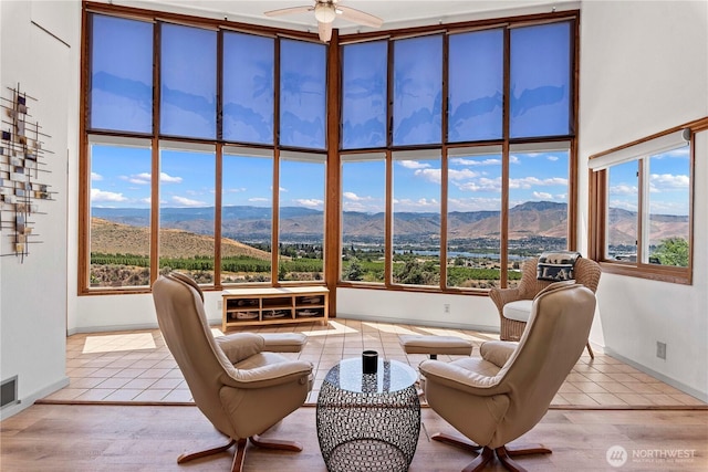 71 Blue Grade Rd, East Wenatchee, WA 98802 - living room featuring a mountain view, a ceiling fan, plenty of natural light, and tile patterned flooring