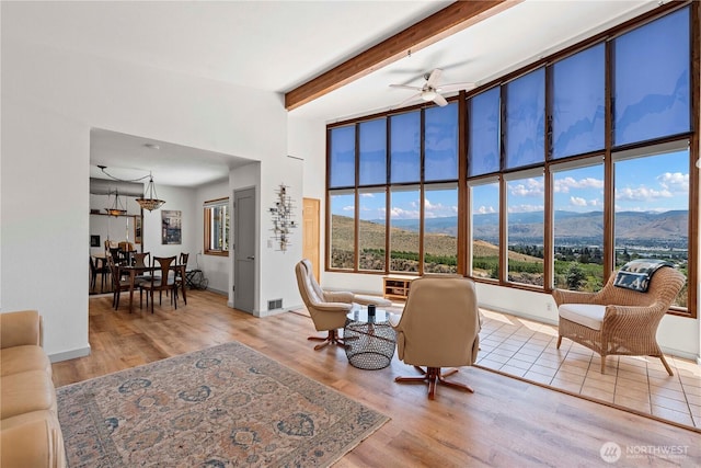 71 Blue Grade Rd, East Wenatchee, WA 98802 - living room with healthy amount of natural light, ceiling fan, a mountain view, wood finished floors, and beamed ceiling