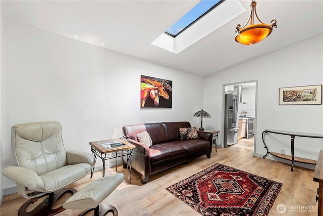 71 Blue Grade Rd, East Wenatchee, WA 98802 - living area featuring a skylight, vaulted ceiling, and light wood-style floors