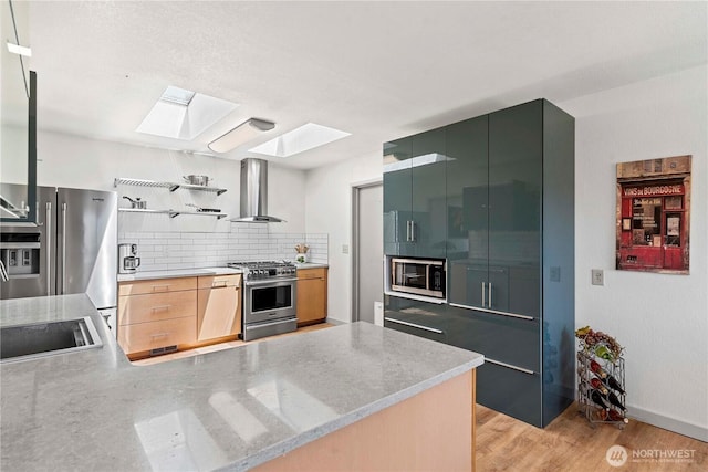 71 Blue Grade Rd, East Wenatchee, WA 98802 - kitchen featuring wall chimney range hood, premium appliances, a skylight, decorative backsplash, and open shelves
