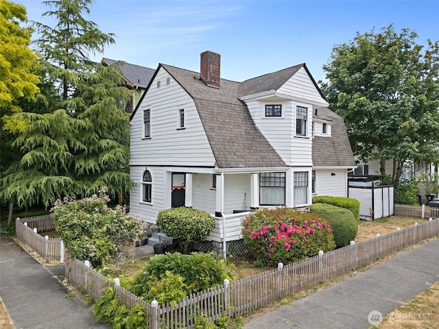 1222 N 4th St, Tacoma, WA 98403 - colonial inspired home with a gambrel roof, a shingled roof, and a chimney