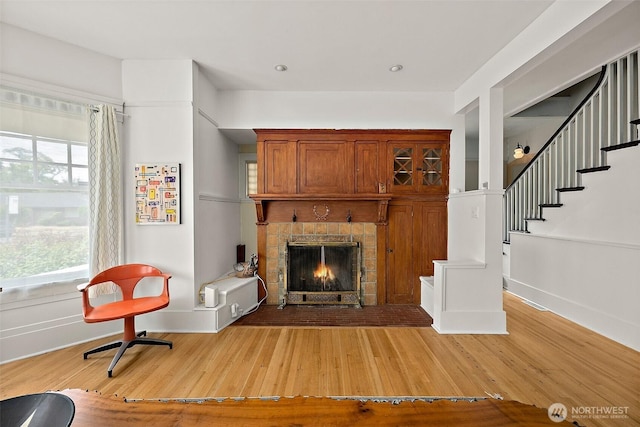 1222 N 4th St, Tacoma, WA 98403 - living area with stairs, healthy amount of natural light, a warm lit fireplace, and light wood-type flooring