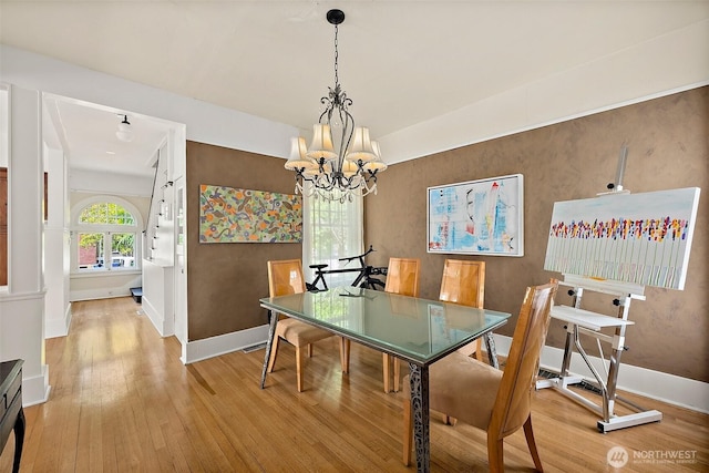 1222 N 4th St, Tacoma, WA 98403 - dining room with light wood-type flooring and a chandelier