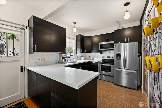 1222 N 4th St, Tacoma, WA 98403 - kitchen with stainless steel appliances, a peninsula, light countertops, and plenty of natural light
