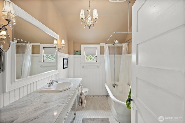 1222 N 4th St, Tacoma, WA 98403 - full bathroom with a chandelier, vanity, vaulted ceiling, tile patterned flooring, and shower / tub combo