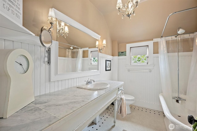 1222 N 4th St, Tacoma, WA 98403 - bathroom with a chandelier, vaulted ceiling, vanity, shower / bath combination with curtain, and a wainscoted wall