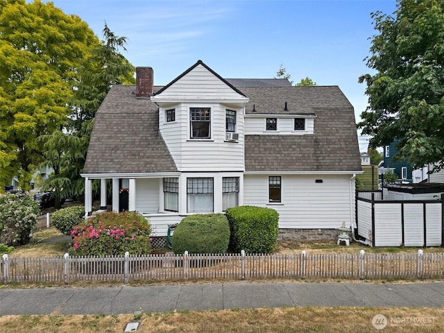 1222 N 4th St, Tacoma, WA 98403 - view of front of home with a shingled roof, covered porch, a chimney, a gambrel roof, and a fenced front yard