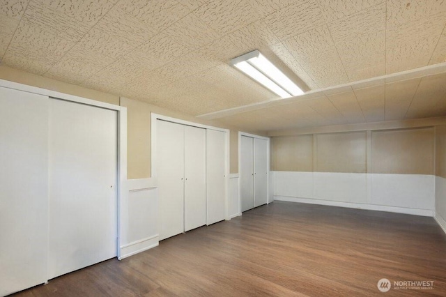 1111 Garrison Ave, Port Orchard, WA 98366 - basement featuring wood finished floors and a decorative wall