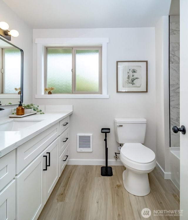 1626 E 59th St, Tacoma, WA 98404 - full bathroom with vanity, wood finished floors, and heating unit