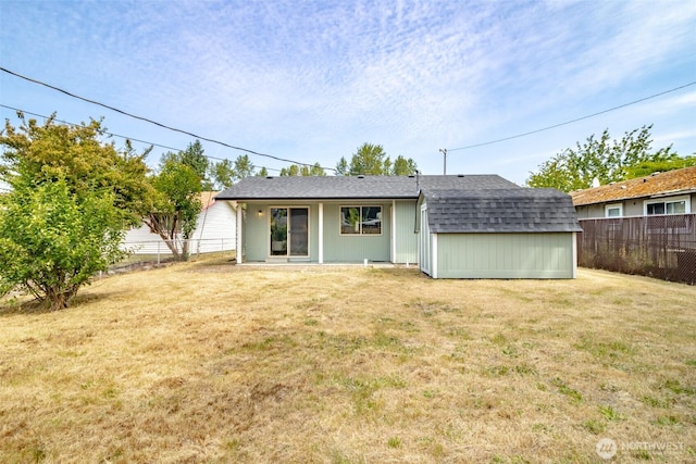 1626 E 59th St, Tacoma, WA 98404 - back of property featuring a fenced backyard and a shingled roof