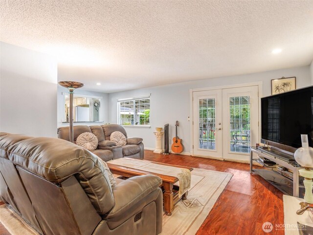 6725 Husky Way SE, Olympia, WA 98503 - living room with wood finished floors, healthy amount of natural light, a textured ceiling, french doors, and recessed lighting
