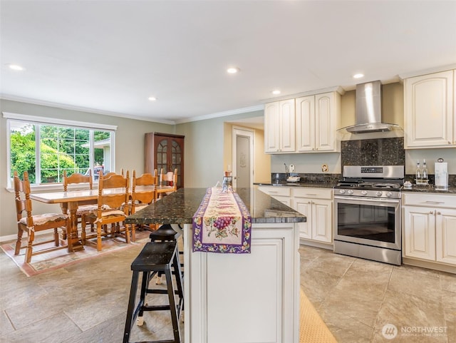 6725 Husky Way SE, Olympia, WA 98503 - kitchen with stainless steel range with gas cooktop, wall chimney range hood, crown molding, recessed lighting, and a kitchen breakfast bar