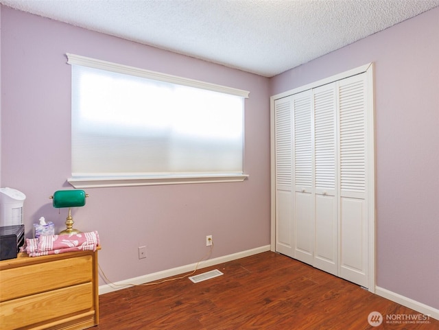 6725 Husky Way SE, Olympia, WA 98503 - unfurnished bedroom with wood finished floors, a closet, and a textured ceiling