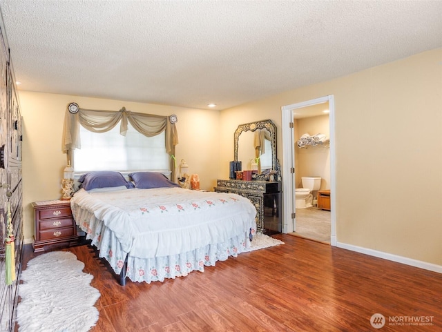 6725 Husky Way SE, Olympia, WA 98503 - bedroom with wood finished floors, a textured ceiling, and ensuite bath