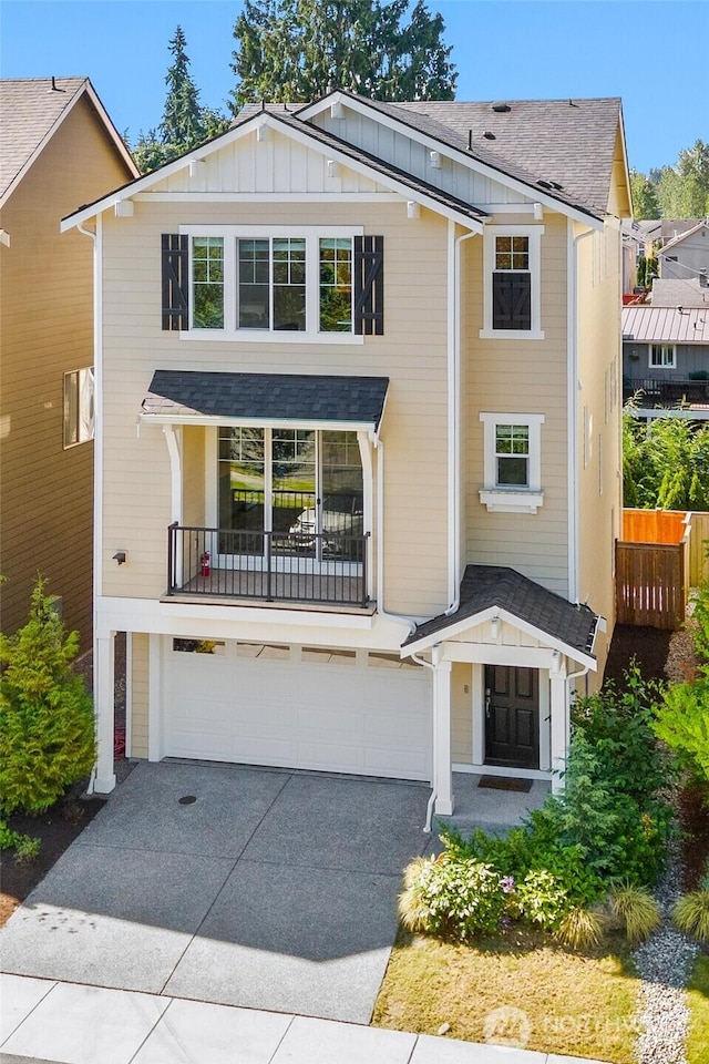 2204 176th Pl SW Unit 3, Lynnwood, WA 98037 - view of front of house featuring an attached garage, driveway, board and batten siding, a balcony, and roof with shingles