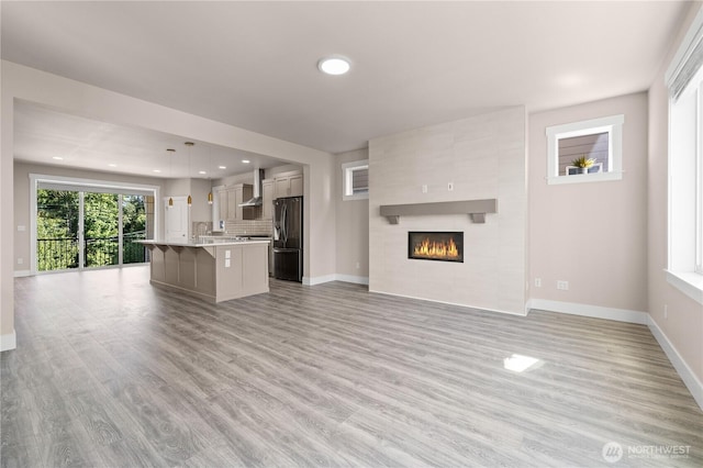 2204 176th Pl SW Unit 3, Lynnwood, WA 98037 - unfurnished living room featuring light wood-style flooring, recessed lighting, and a fireplace