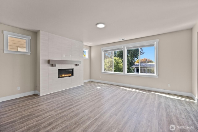 2204 176th Pl SW Unit 3, Lynnwood, WA 98037 - unfurnished living room featuring wood finished floors and a tile fireplace