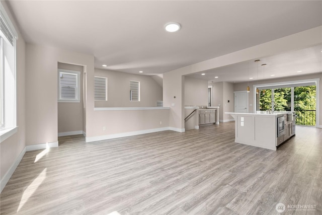 2204 176th Pl SW Unit 3, Lynnwood, WA 98037 - unfurnished living room featuring recessed lighting and light wood-style floors