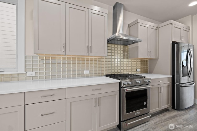 2204 176th Pl SW Unit 3, Lynnwood, WA 98037 - kitchen featuring stainless steel appliances, wall chimney range hood, light wood-style flooring, and light countertops
