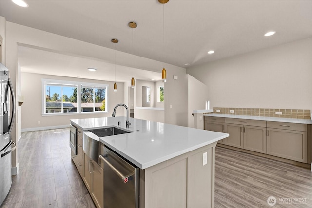 2204 176th Pl SW Unit 3, Lynnwood, WA 98037 - kitchen featuring stainless steel appliances, healthy amount of natural light, a center island with sink, light wood-style floors, and recessed lighting