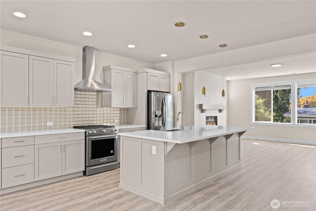 2204 176th Pl SW Unit 3, Lynnwood, WA 98037 - kitchen featuring appliances with stainless steel finishes, wall chimney exhaust hood, light countertops, tasteful backsplash, and recessed lighting