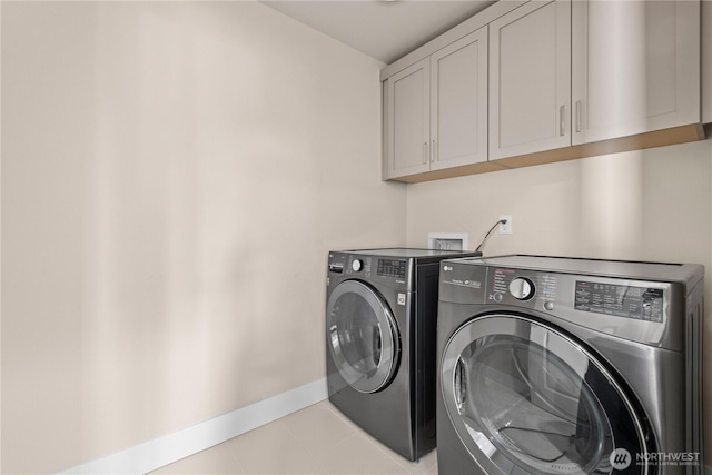 2204 176th Pl SW Unit 3, Lynnwood, WA 98037 - laundry area featuring cabinet space, washer and dryer, and light tile patterned flooring