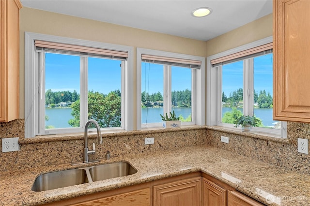 3607 Walthew Dr SE, Lacey, WA 98503 - kitchen with decorative backsplash, light brown cabinetry, light stone counters, a water view, and recessed lighting