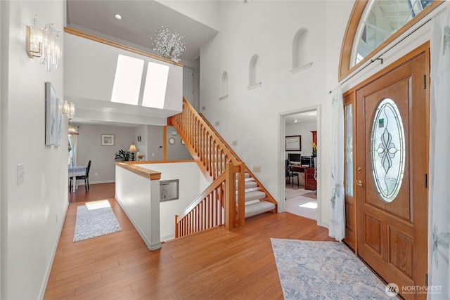 3607 Walthew Dr SE, Lacey, WA 98503 - foyer entrance featuring a towering ceiling, wood finished floors, stairway, and healthy amount of natural light