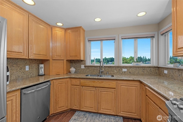 3607 Walthew Dr SE, Lacey, WA 98503 - kitchen with appliances with stainless steel finishes, decorative backsplash, recessed lighting, wood finished floors, and light stone countertops