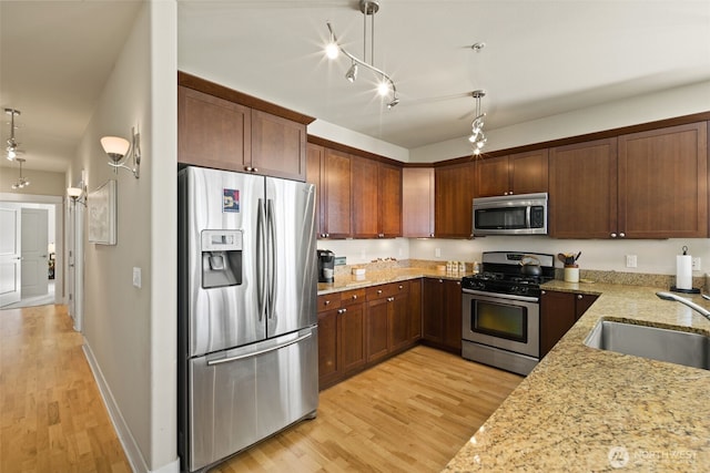616 Glen St Unit 101, Edmonds, WA 98020 - kitchen with appliances with stainless steel finishes, light wood finished floors, and light stone counters