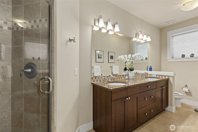 616 Glen St Unit 101, Edmonds, WA 98020 - full bathroom featuring double vanity, tile patterned flooring, and a shower stall