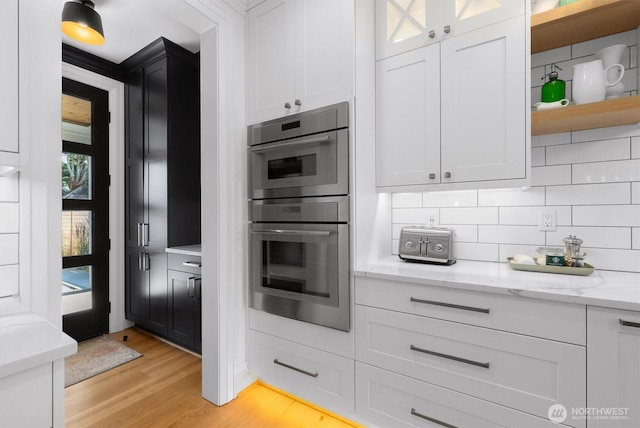 3705 N 18th St, Tacoma, WA 98406 - kitchen with double oven, white cabinets, and tasteful backsplash