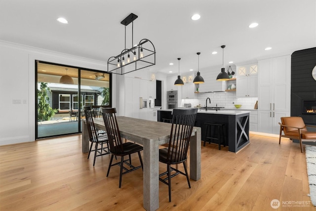3705 N 18th St, Tacoma, WA 98406 - dining space with recessed lighting, light wood finished floors, crown molding, and a large fireplace