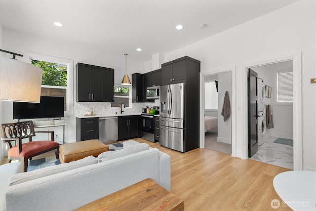 3705 N 18th St, Tacoma, WA 98406 - living area featuring stacked washer and clothes dryer and recessed lighting