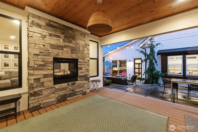 3705 N 18th St, Tacoma, WA 98406 - living room with wooden ceiling, an outdoor stone fireplace, wood finished floors, and crown molding