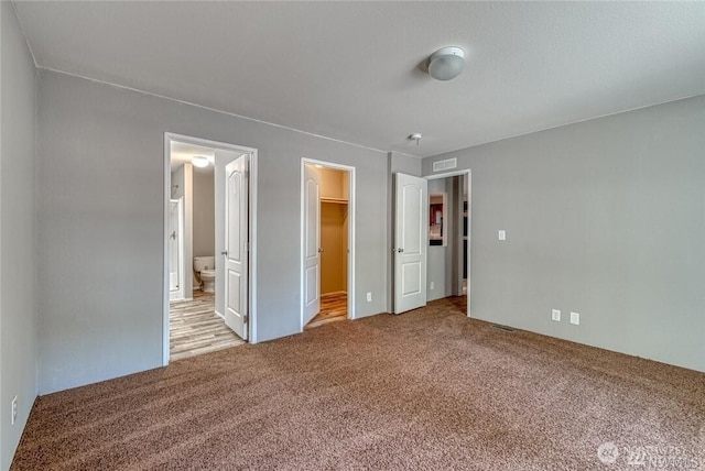911 Mill Crk, Shelton, WA 98584 - unfurnished bedroom featuring carpet floors, a spacious closet, ensuite bathroom, and a closet